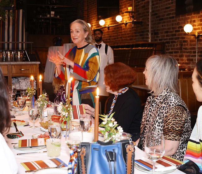A group of people sitting around a dinner table