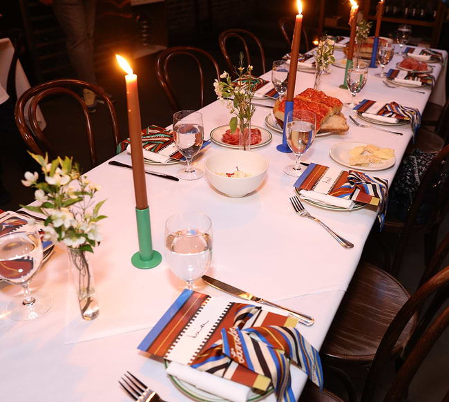 A table set for a formal dinner with candles
