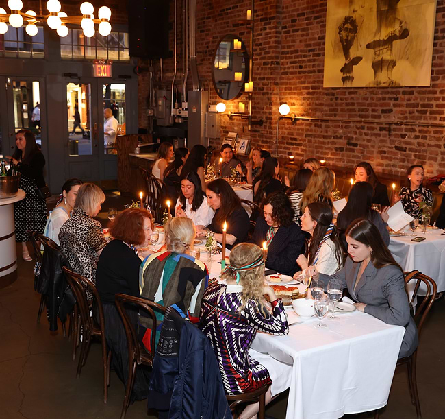 A large group of people sitting at tables in a restaurant