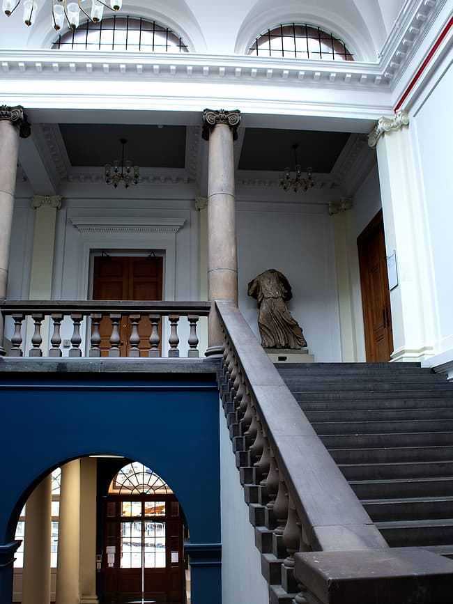 A staircase with a statue of a dog on top of it
