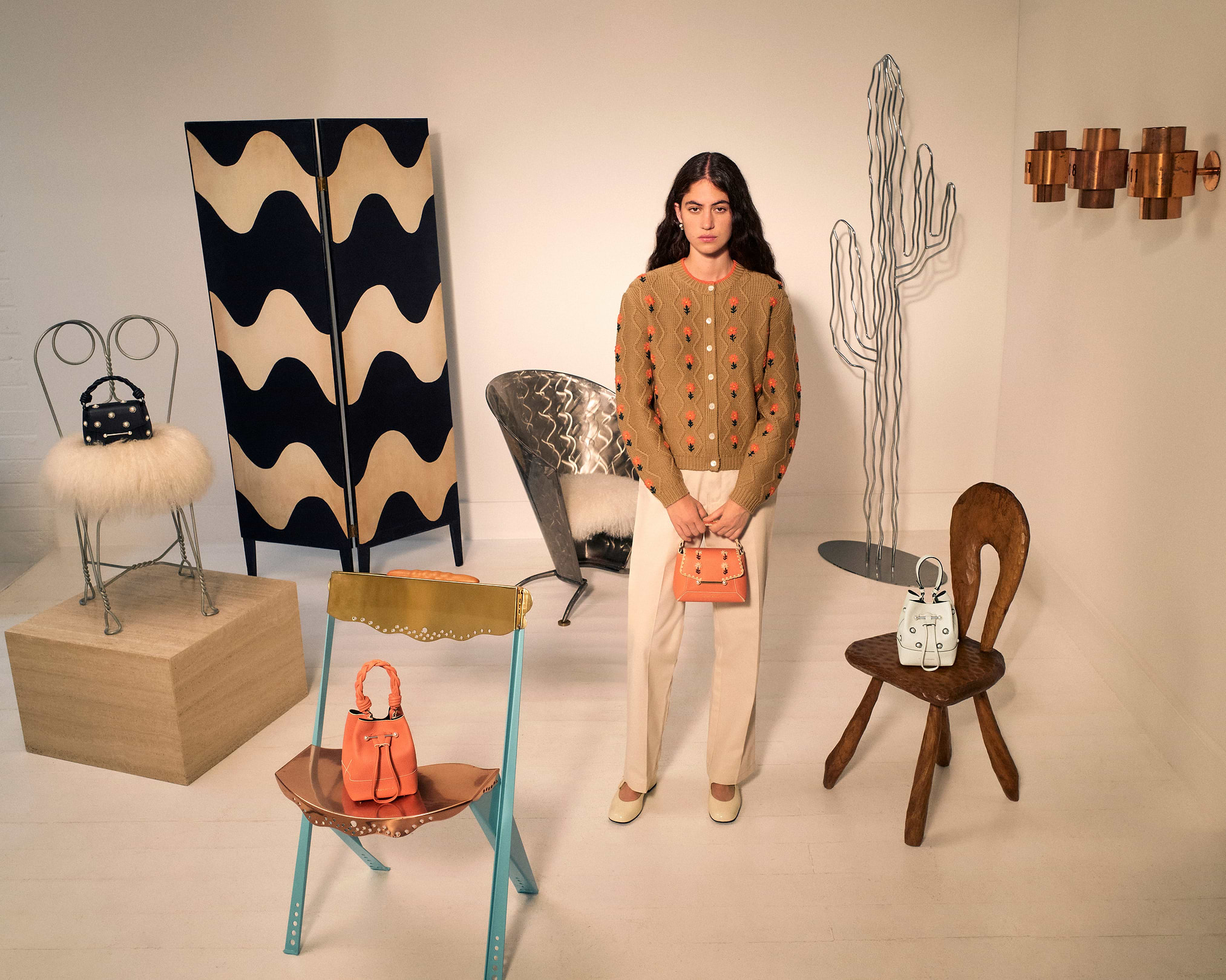 A woman standing in front of a display of furniture