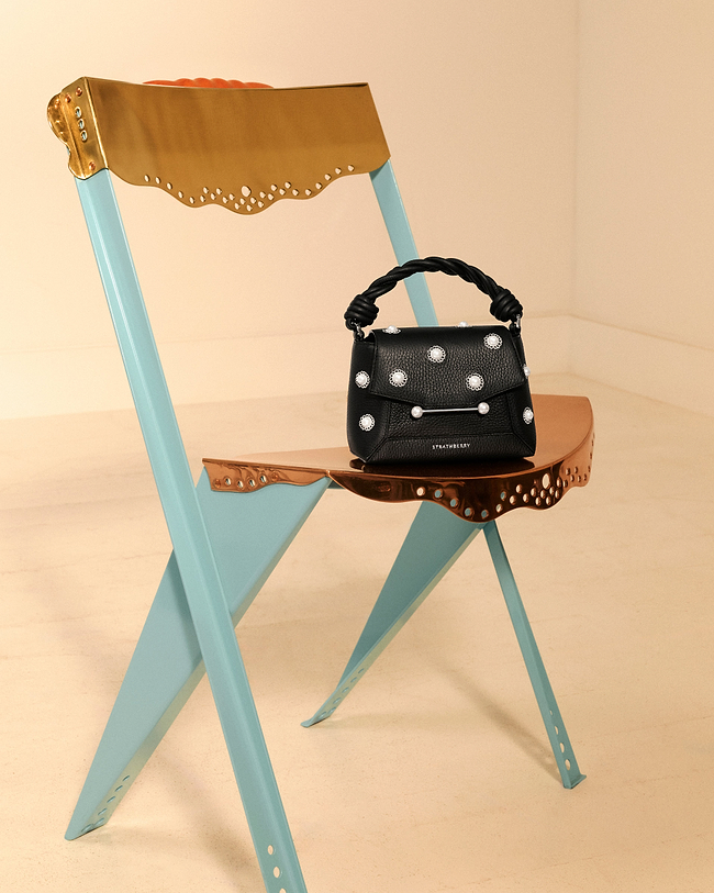 A chair with a purse sitting on top of it