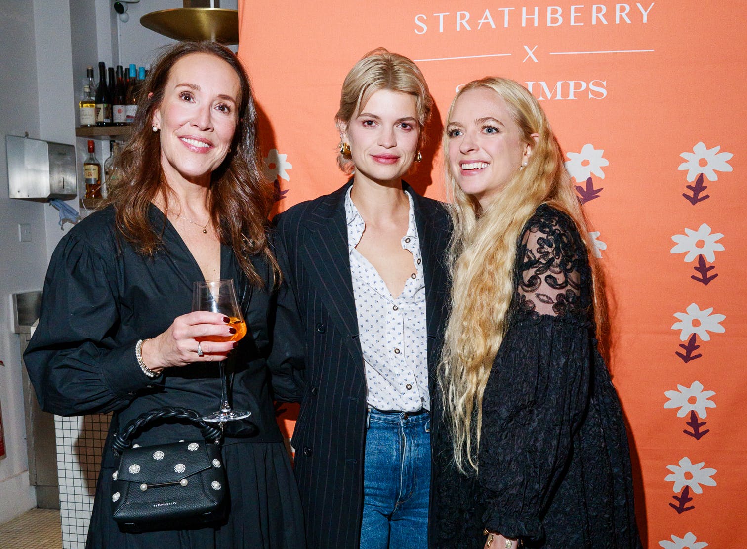 A group of three women standing next to each other