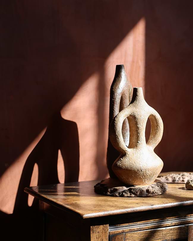 A vase sitting on top of a wooden table