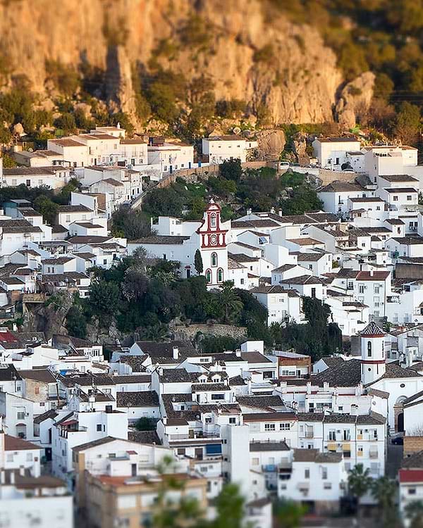 A small town with a steeple and a clock tower
