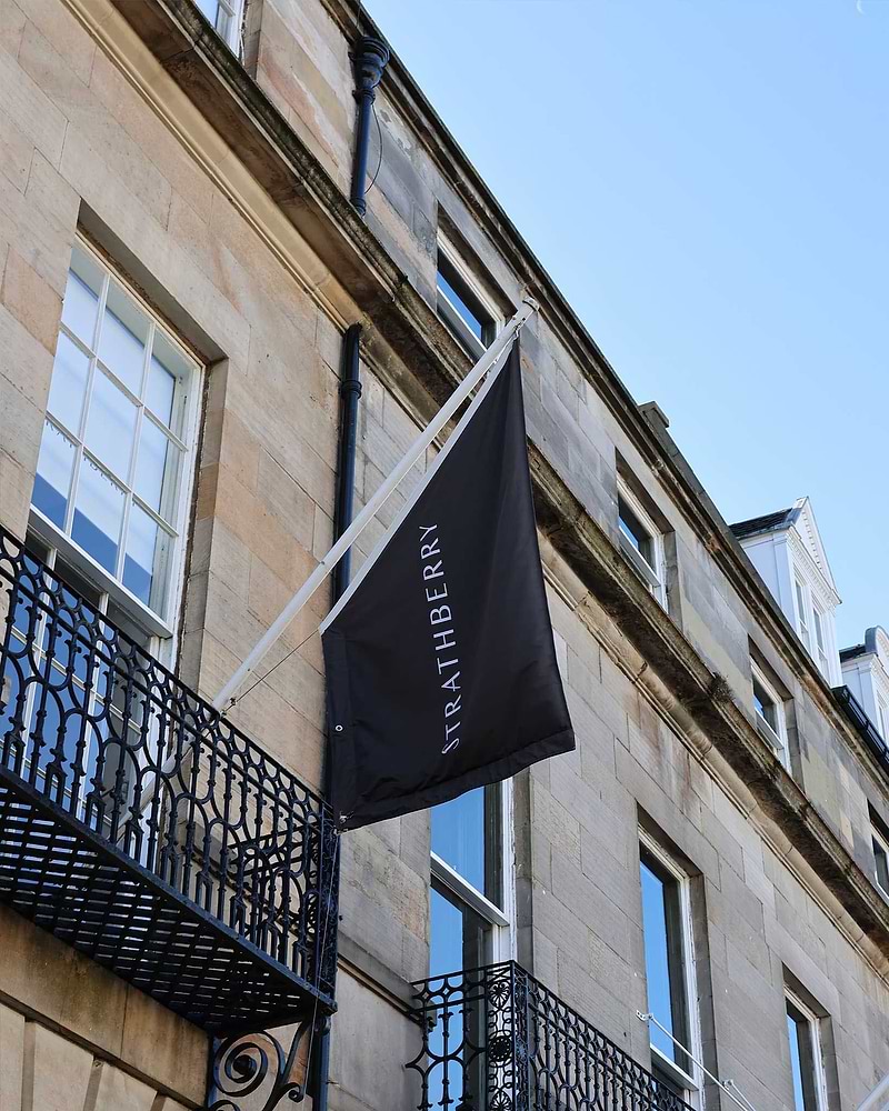 A black flag hanging from the side of a building