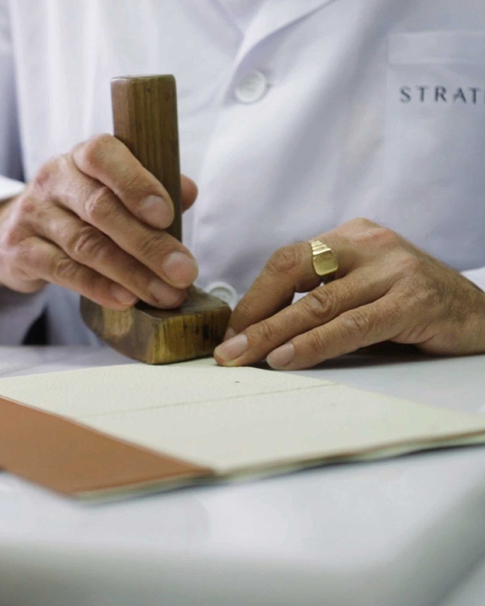 A close up of a person with a ring on a table