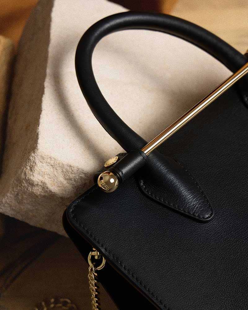 A black purse sitting on top of a table