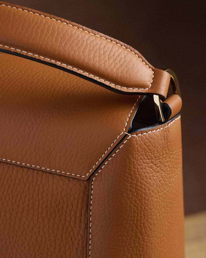 A close up of a brown leather bag