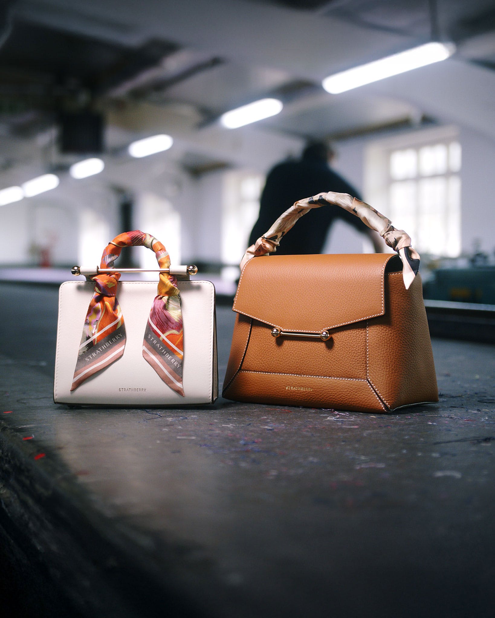 A purse and a handbag sitting on the ground