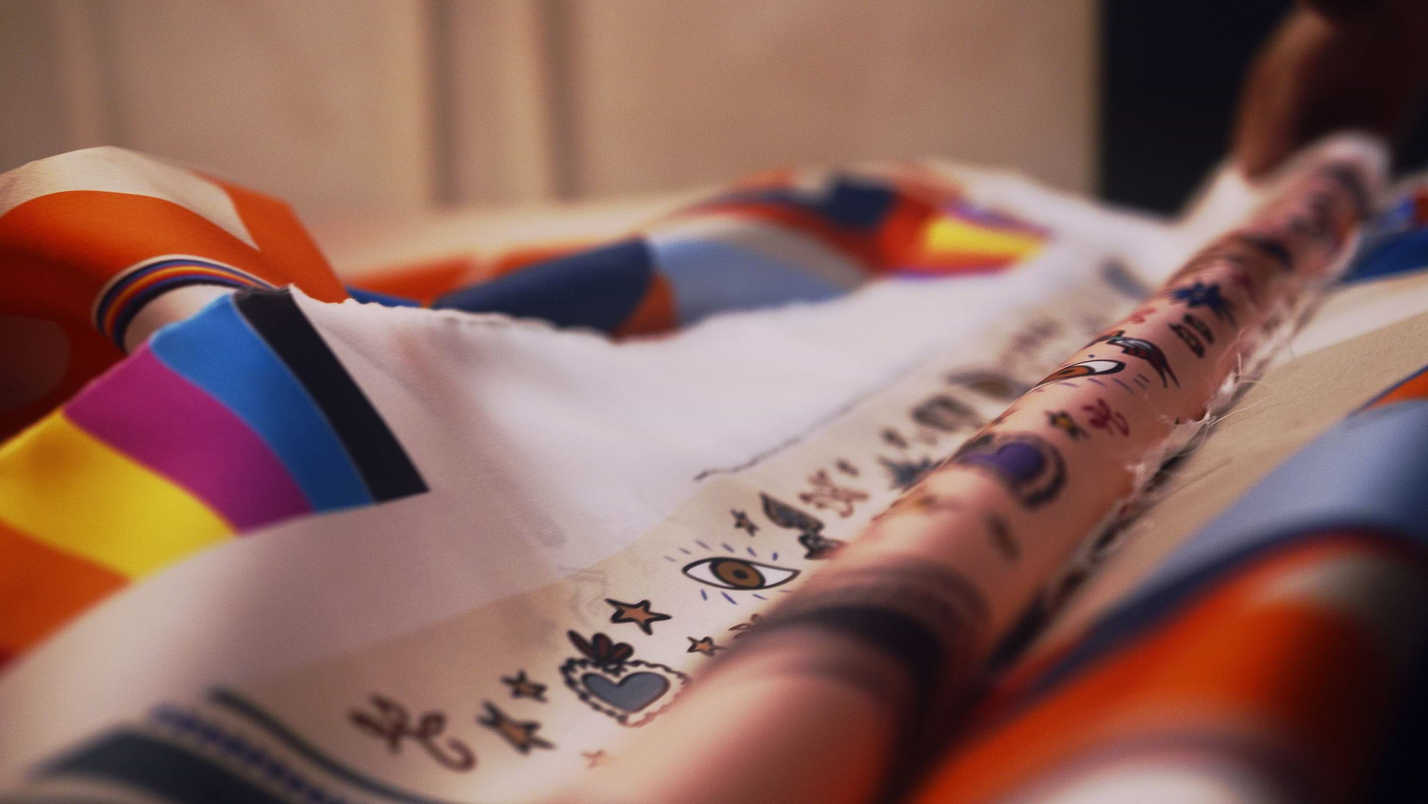 A close up of a person's arm with tattoos on it