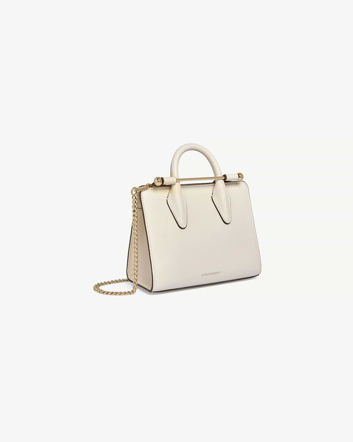 Strathberry nano tote in vanilla leather with top handle and gold chain strap.