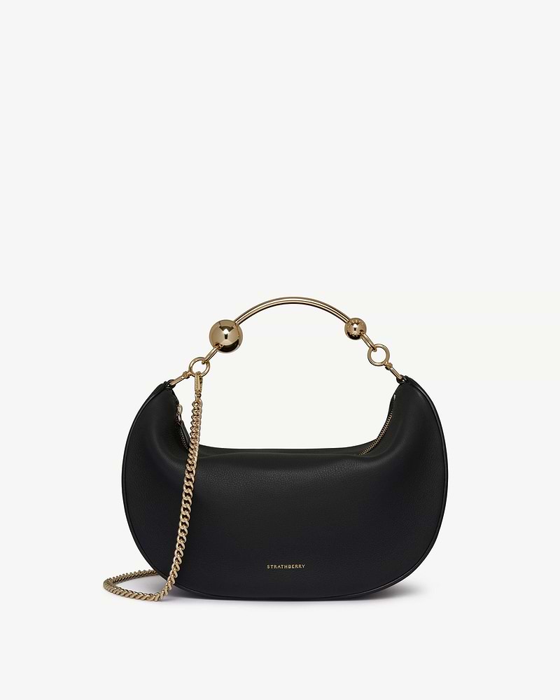 Black Crescent Moon bag with gold ball handle, chain strap and Strathberry logo.