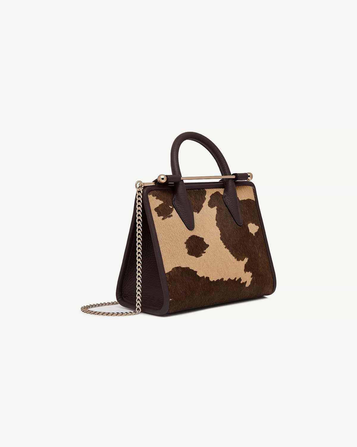 Mini tote with sand and espresso spot print, top handles and gold chain strap.