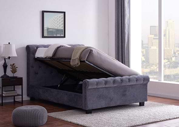An elegant Chesterfield style ottoman bed frame upholstered in a plush grey fabric.