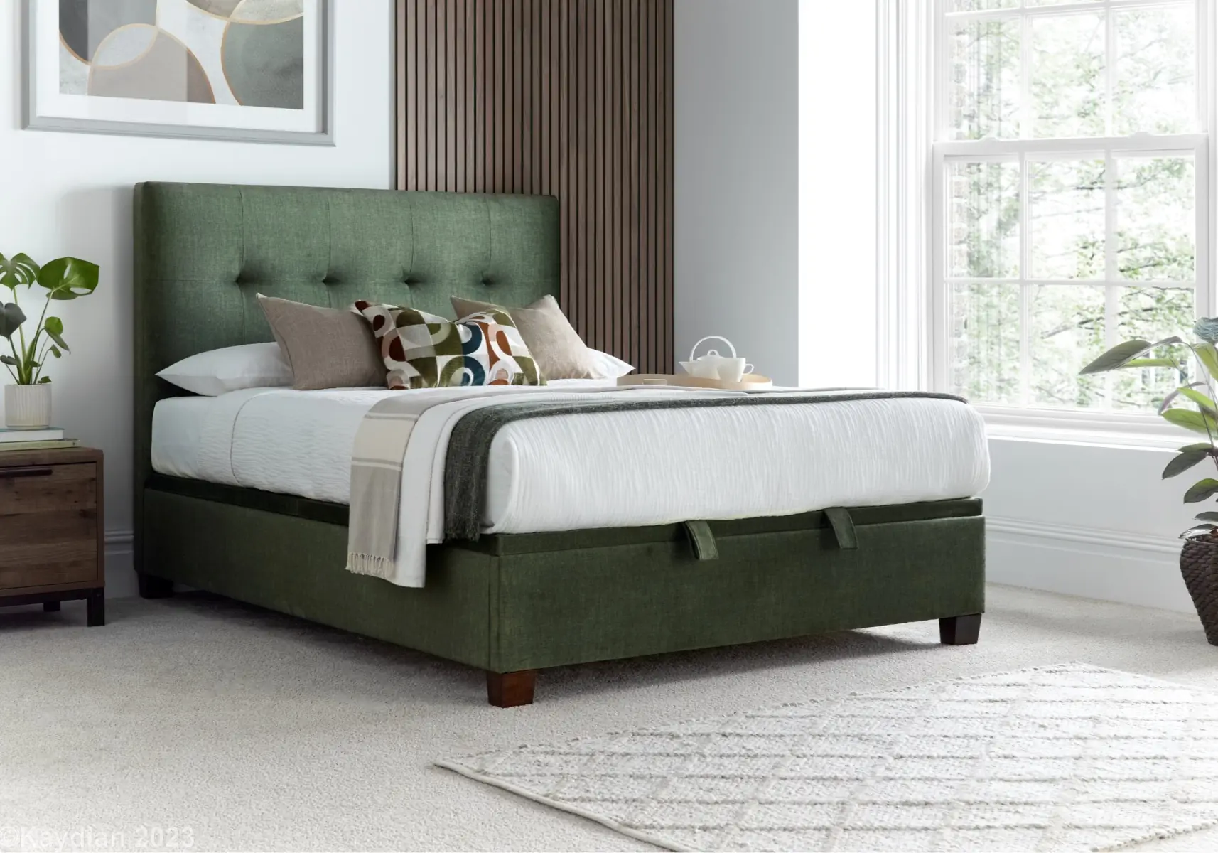 Green ottoman bed with white, brown and green bedsheets