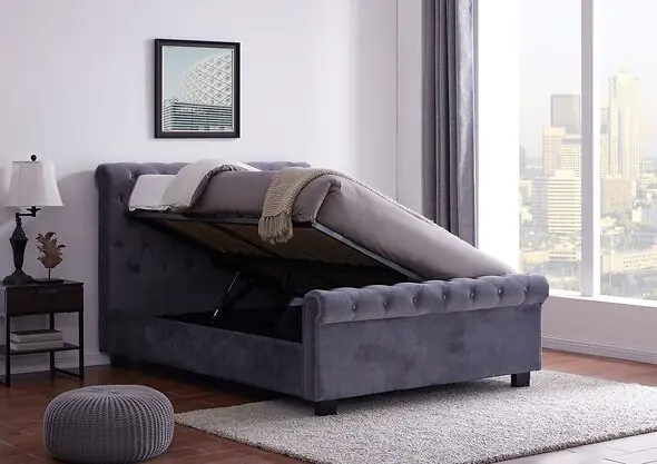 An elegant Chesterfield style ottoman bed frame upholstered in a plush grey fabric.