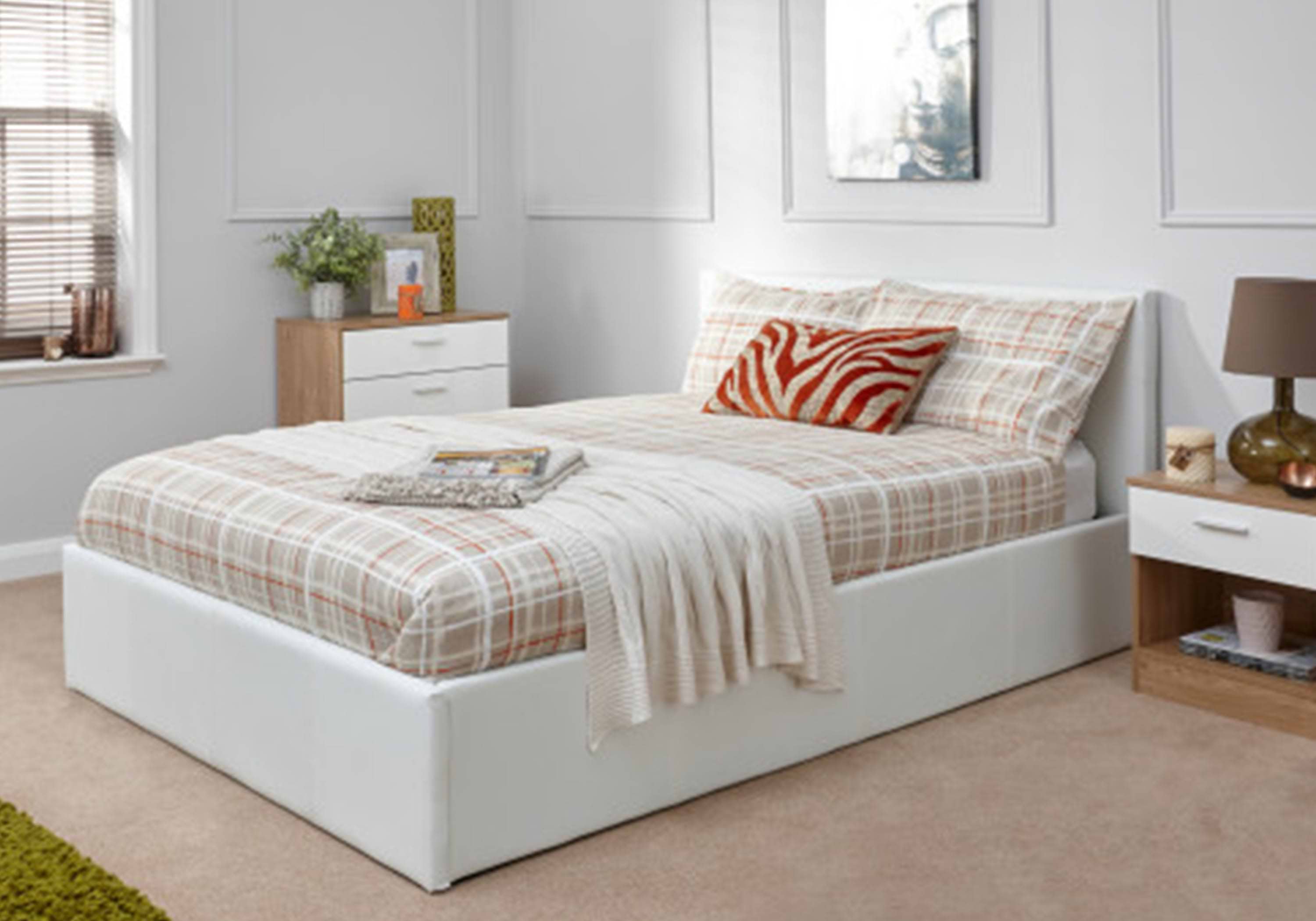 White ottoman bed with checkered brown sheets and natural/white wood furniture
