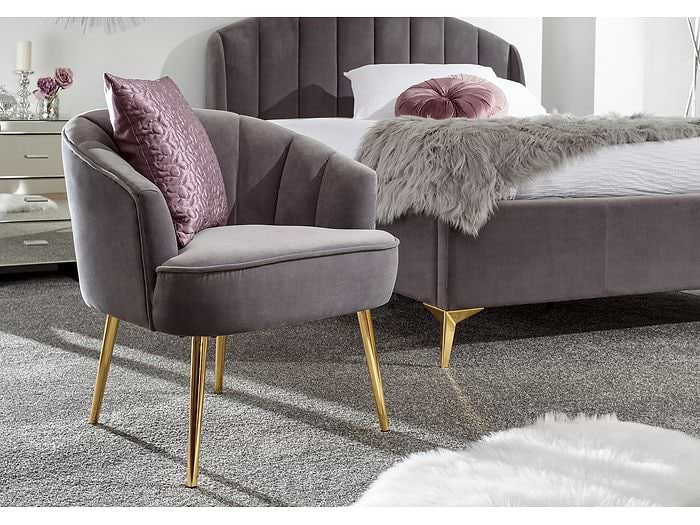 Elegant deep cushioned fabric chair with angled gold legs available in grey, teal, royal blue and pink