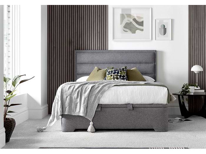 A luxurious contemporary ottoman bed frame with a modern horizontal padded headboard in grey fabric