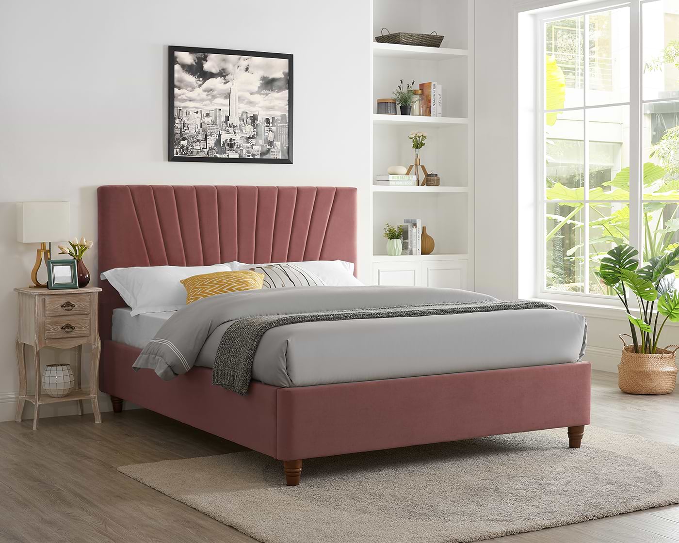 Pink double bed with grey sheets