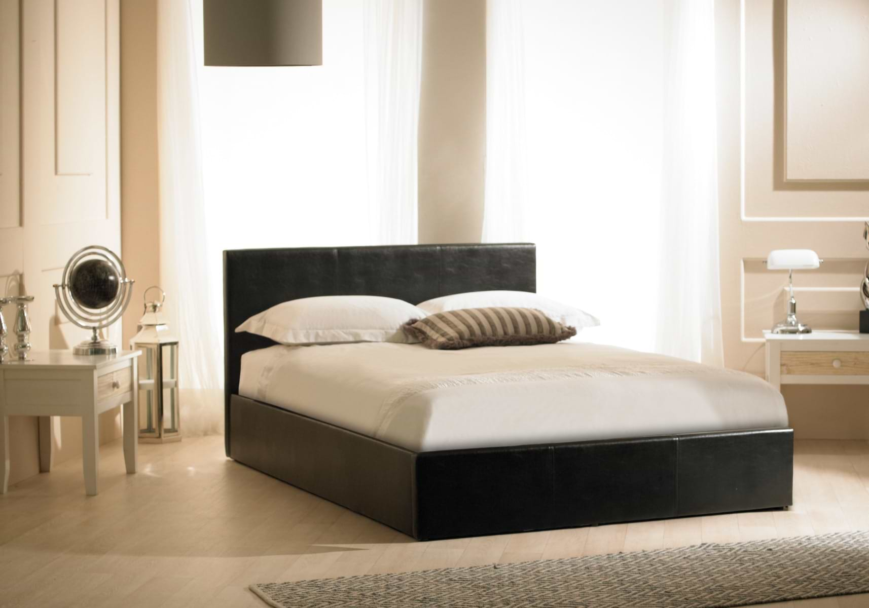 Black single storage bed with green and grey bed sheets