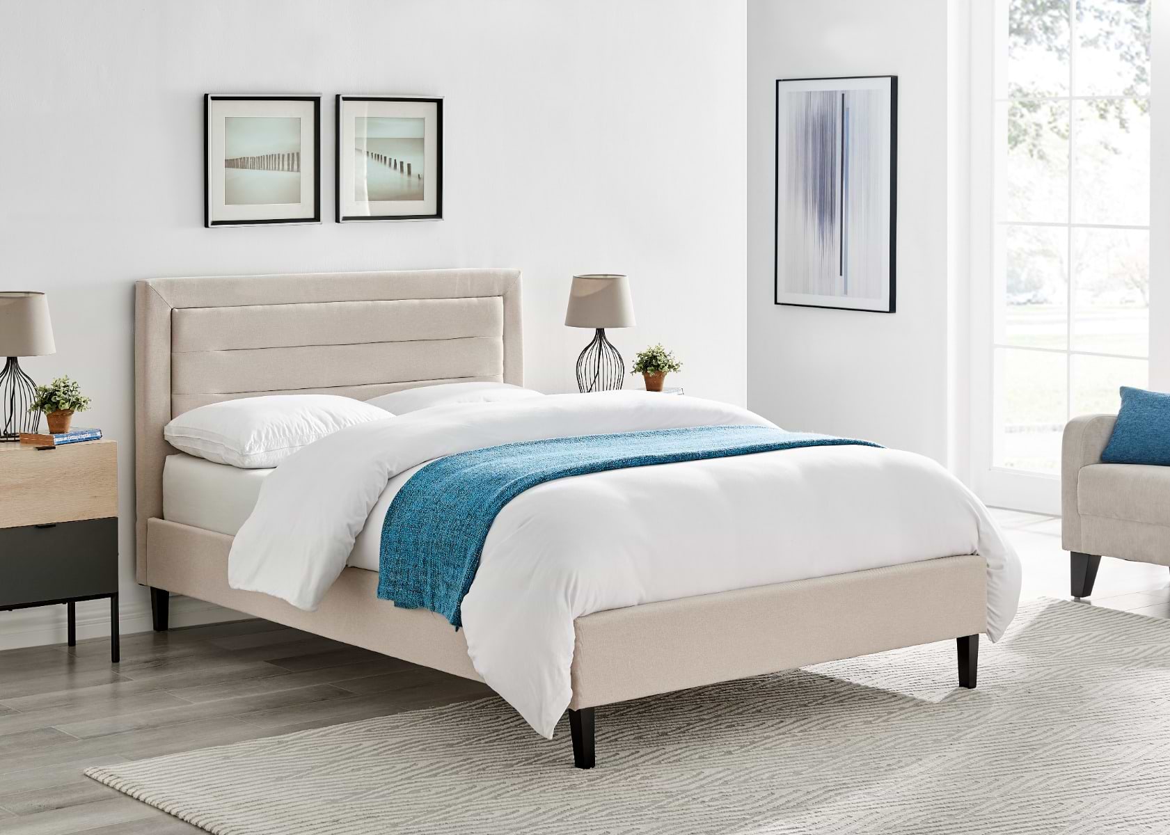 Beige double bed with blue and white bedsheets