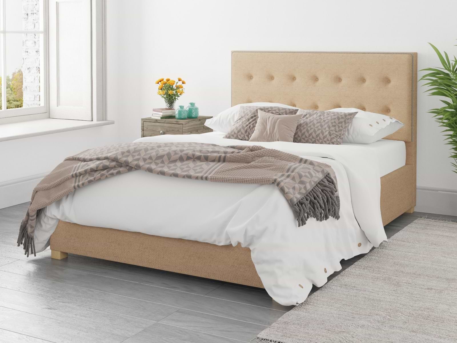 Beige double ottoman bed with brown and white bedsheets