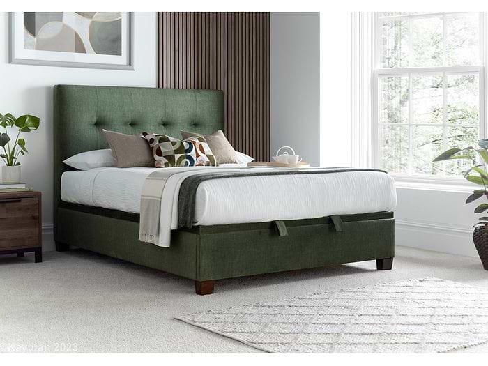 Luxurious moss green velvet ottoman bed frame with modern dark wooden feet. Luxurious moss green velvet ottoman bed frame with modern dark wooden feet.