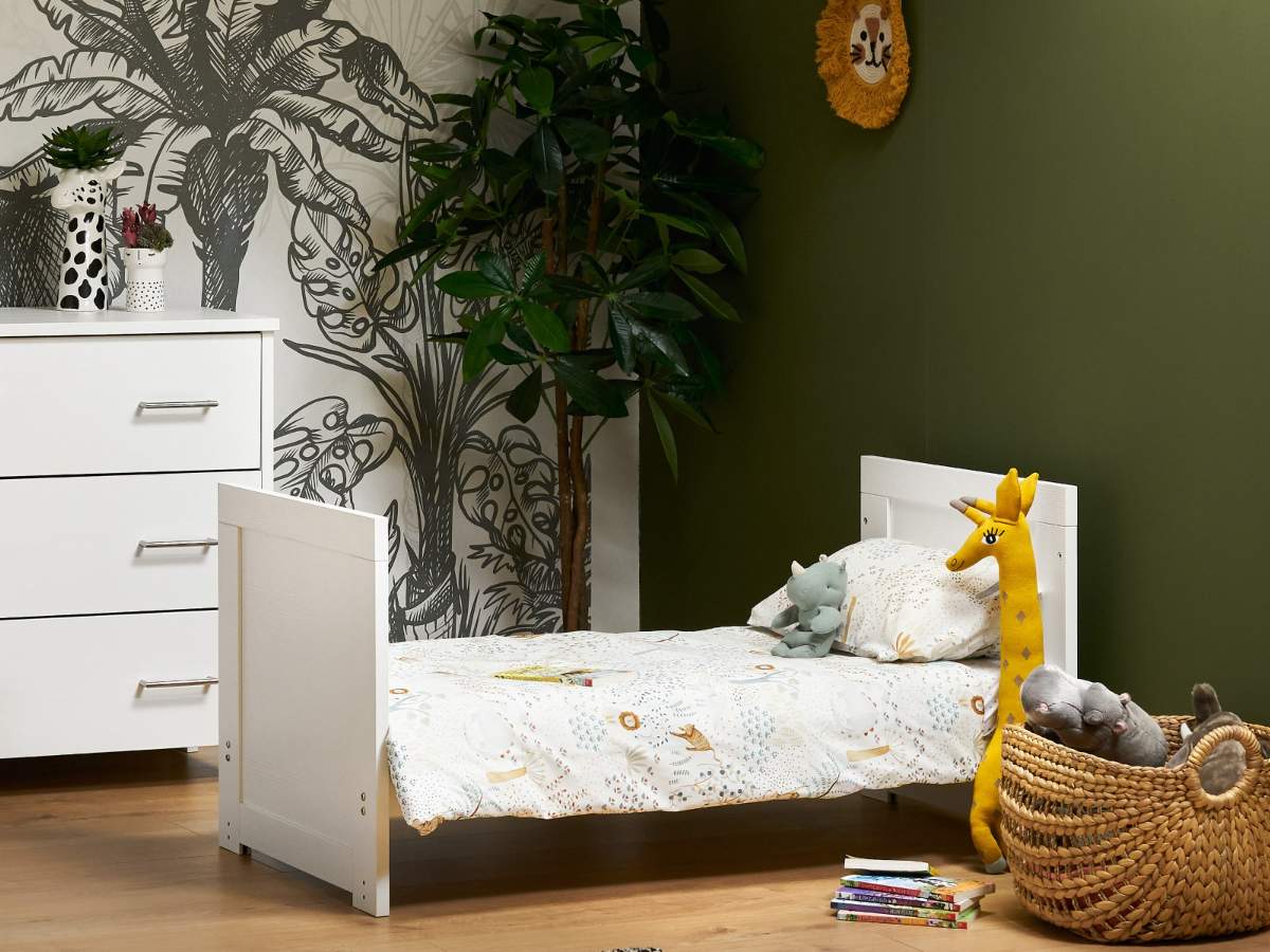 white adaptable cot that is in bed form