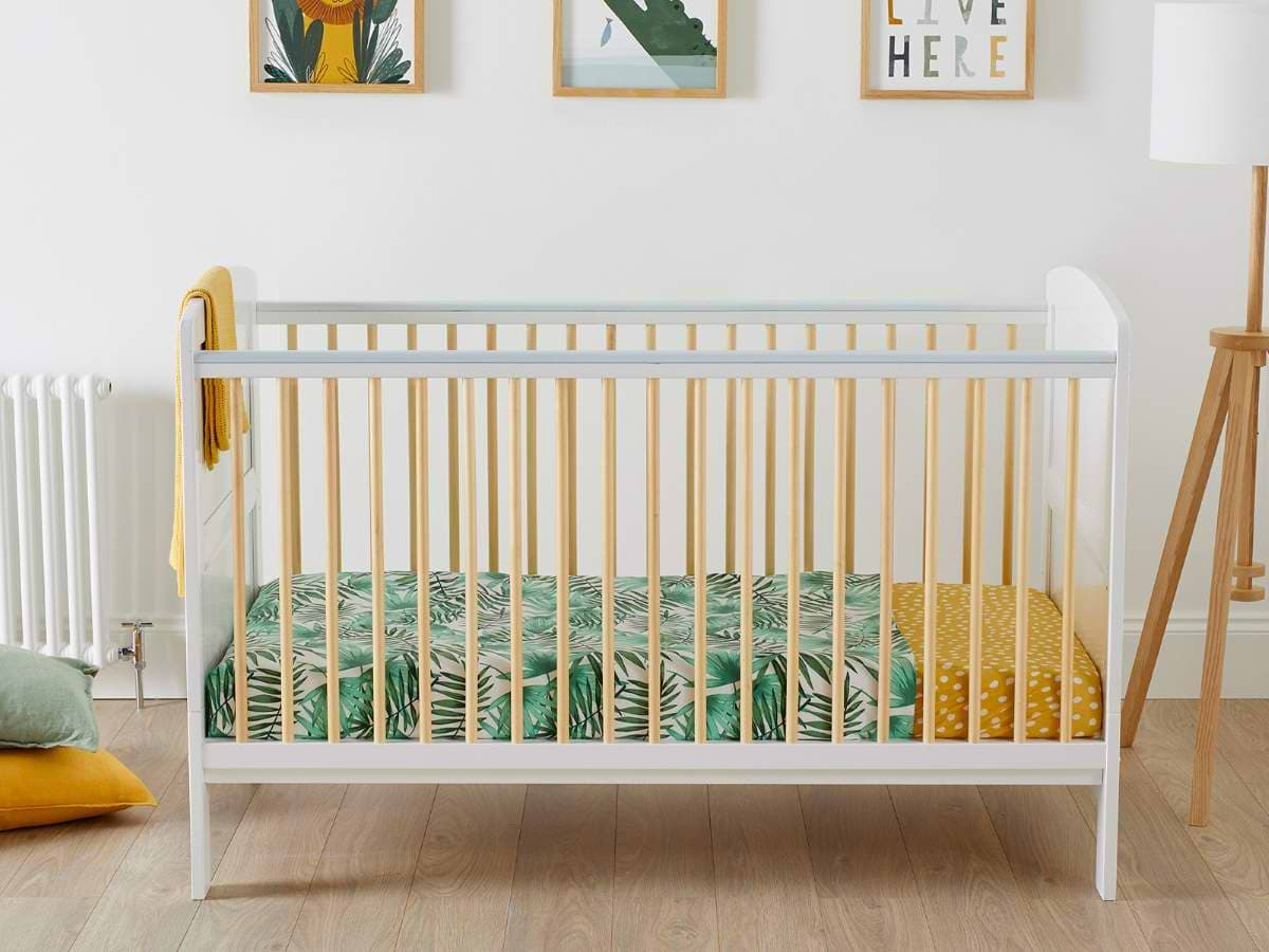 white classic cot with yellow bars