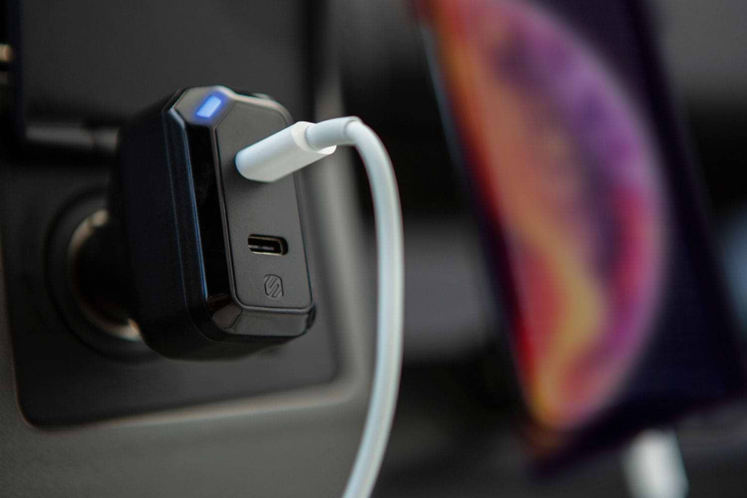 USB fast charger plugged into vehicle 12V socket with cable attached