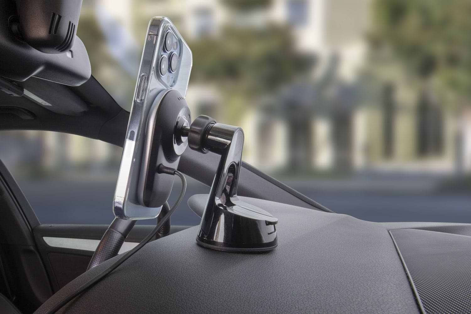 iphone13 mounted to wireless charger on car dash