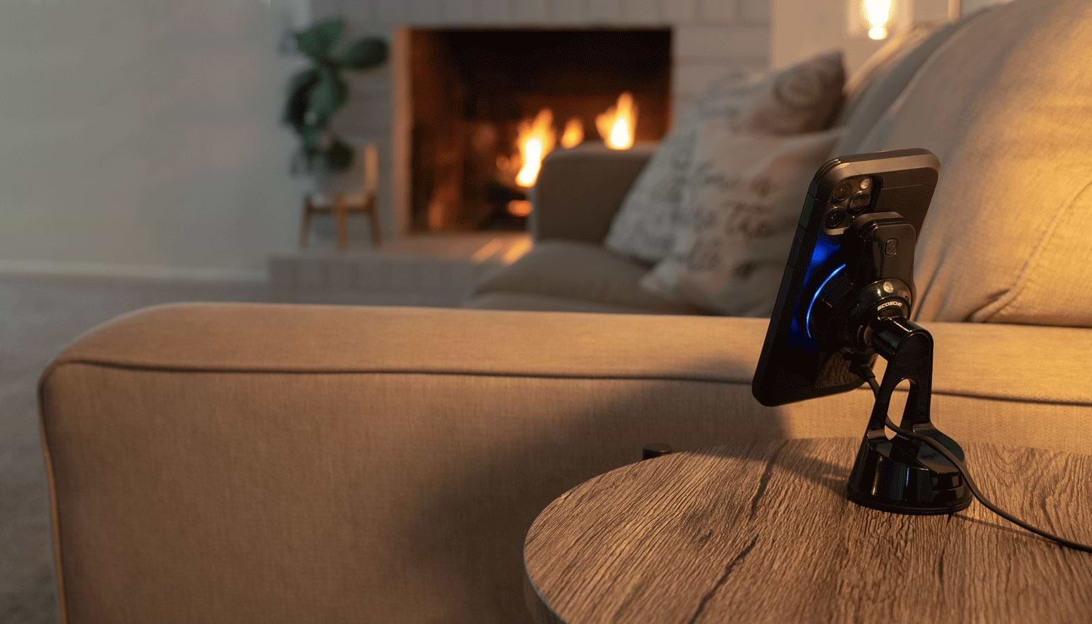 iphone mounted to wireless charger sitting on table in living room next to sofa