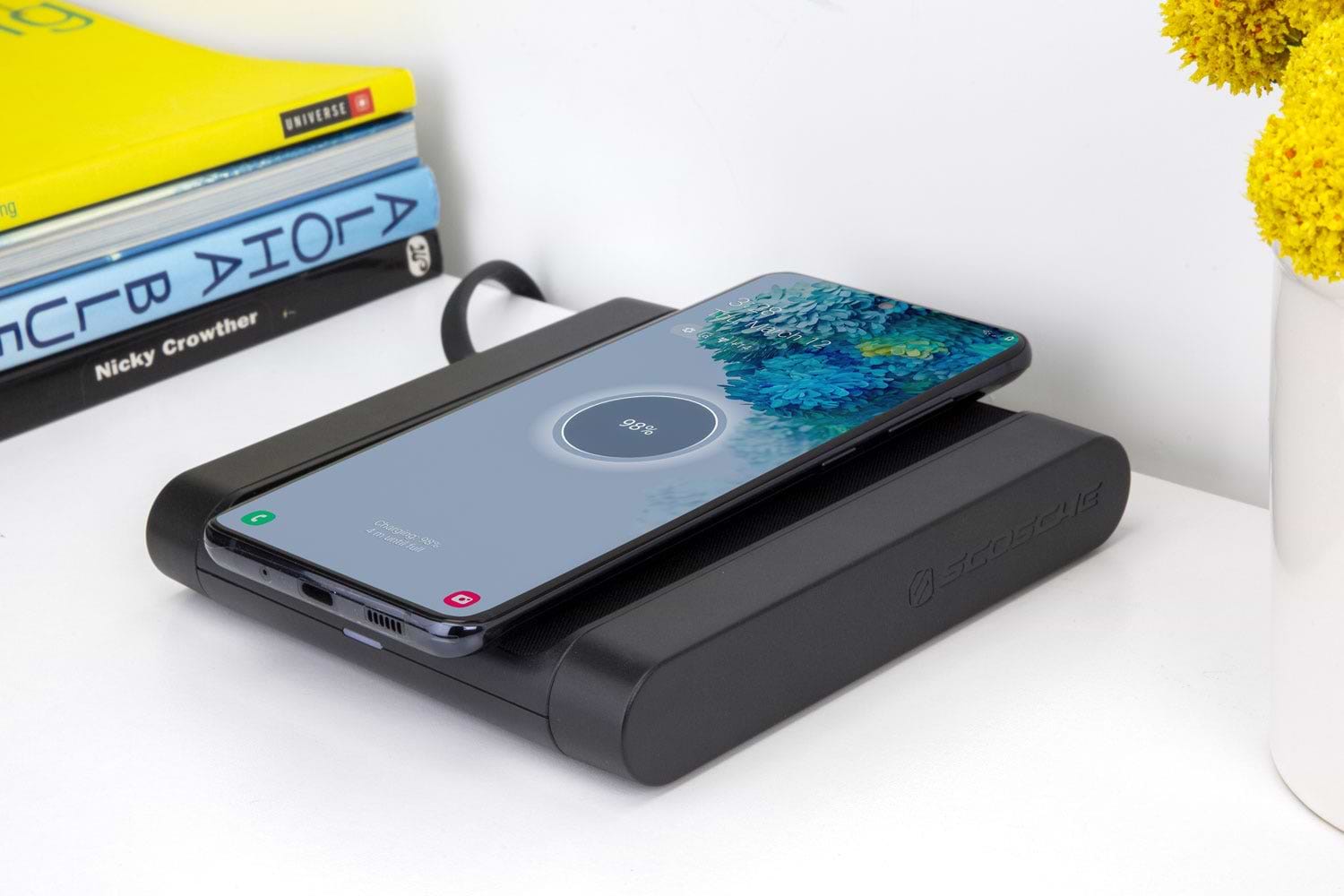 Samsung phone charging via Scosche wireless charging pad on tabletop