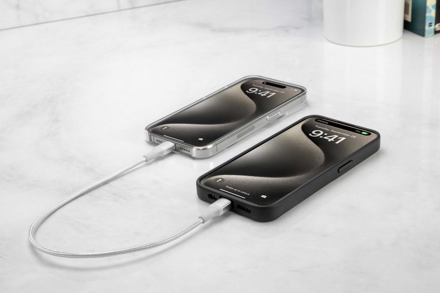 two iphones syncing via Scosche braided cable on countertop