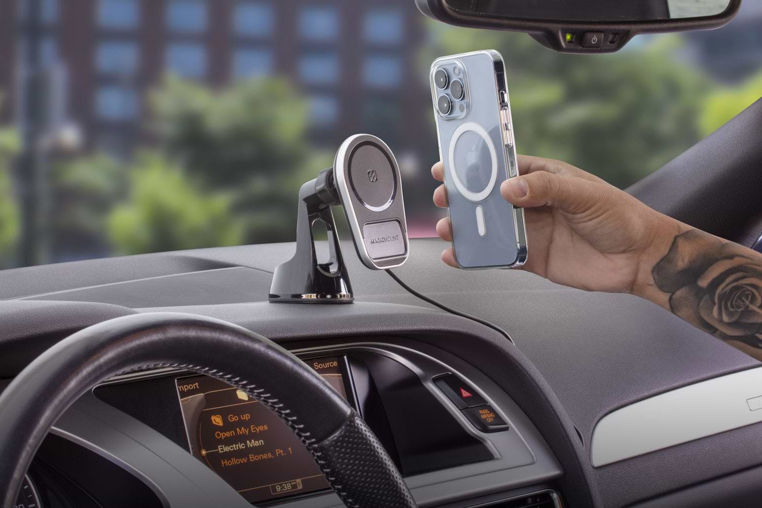wireless charging mount on car dash with person hovering iphone 13 over mount surface