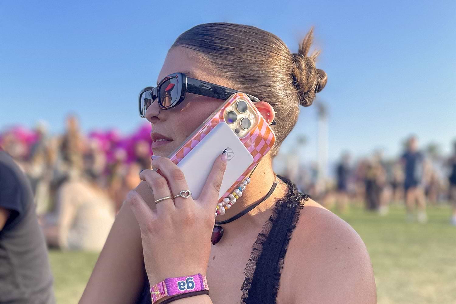 woman talking on iphone with Scosche magsafe power bank attached