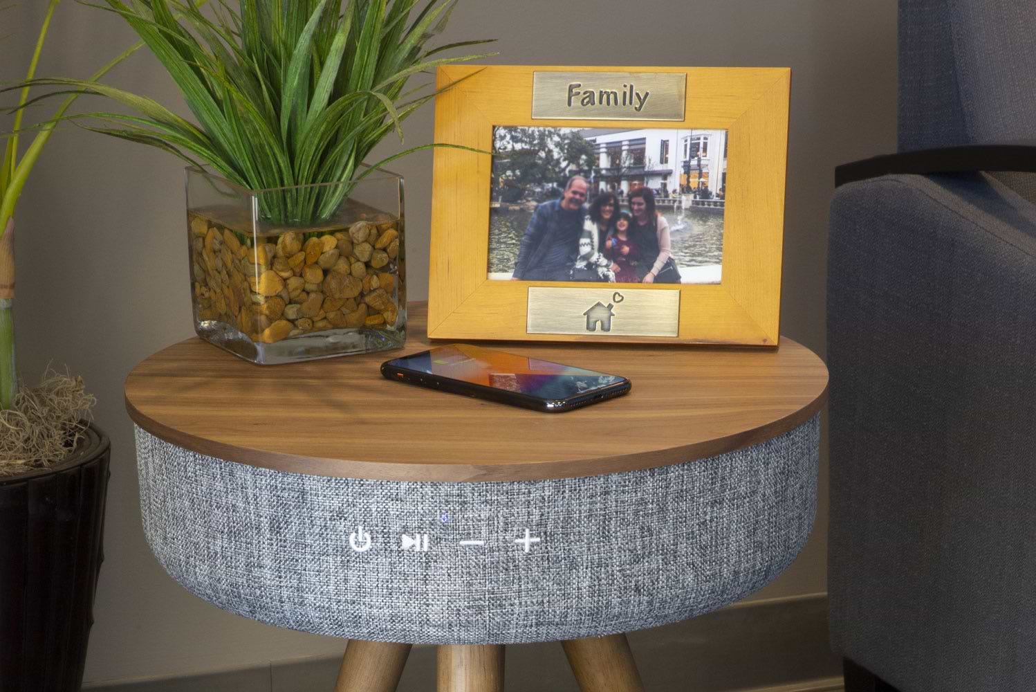 phone charging via Scosche wireless charging table in living room