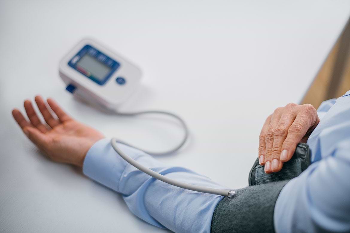 blood pressure monitor man using blood pressure monitor