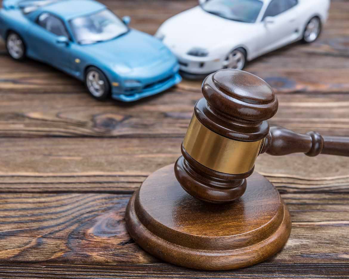 gavel of a judge gavel of a judge with two cars hitting in background