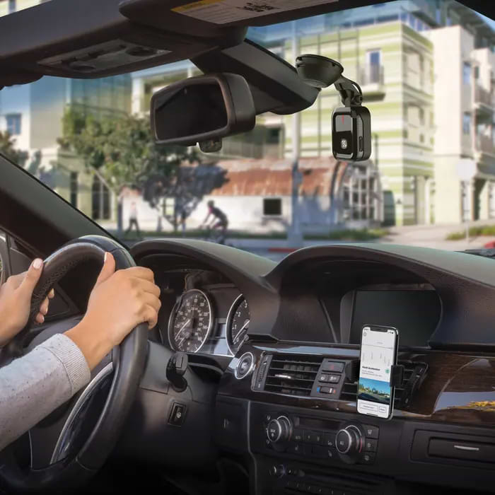 nexs1 smart dash camera woman driving with nexs1 smart dash camera on car windshield