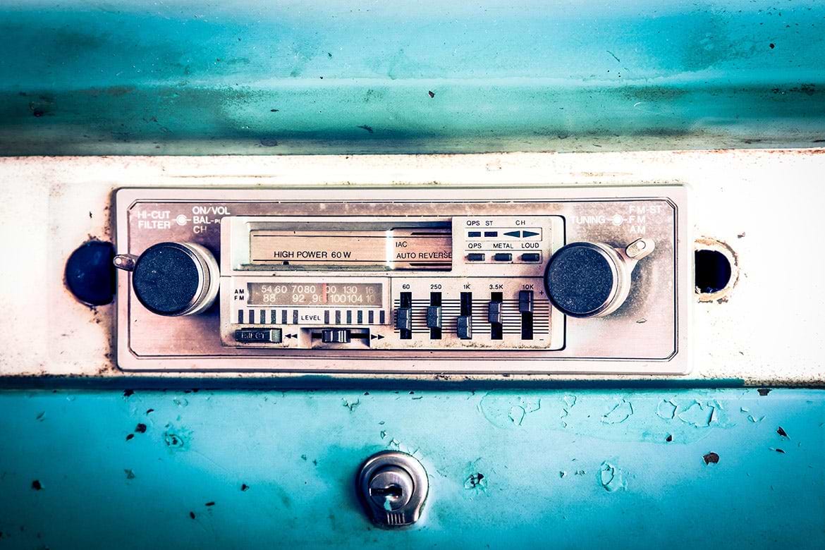 old car radio rusted old-looking analog car radio on blue dash with peeling paint