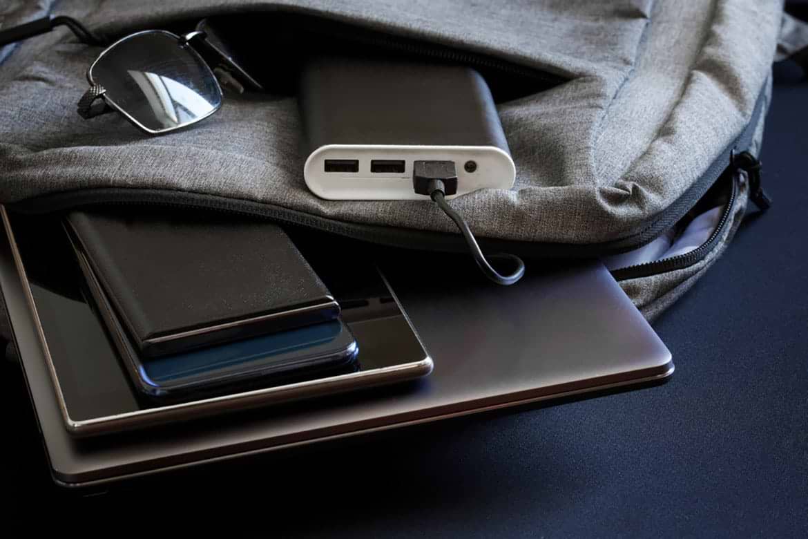 portable charger power bank portable charger power bank in bag next to iphone and ipad