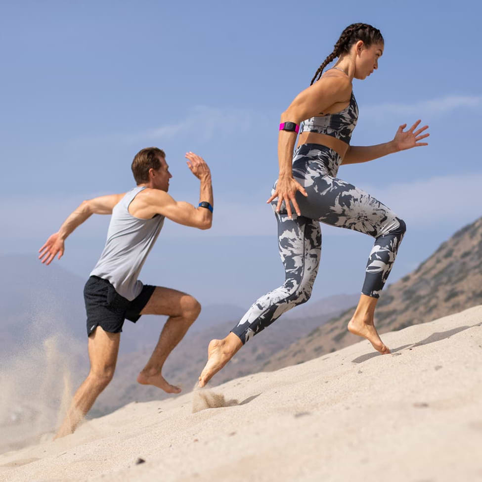 running with heart rate monitor armband man and woman running with heart rate monitor armband
