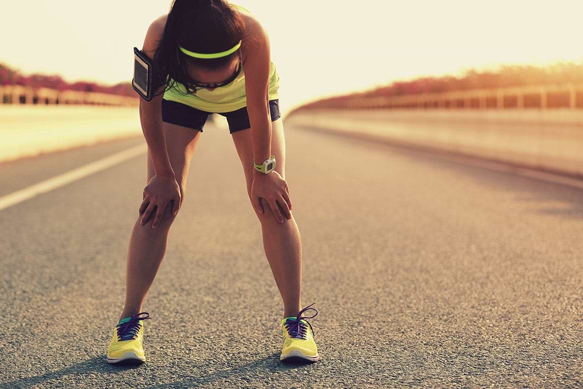 tired woman runner woman bending over tired from funning