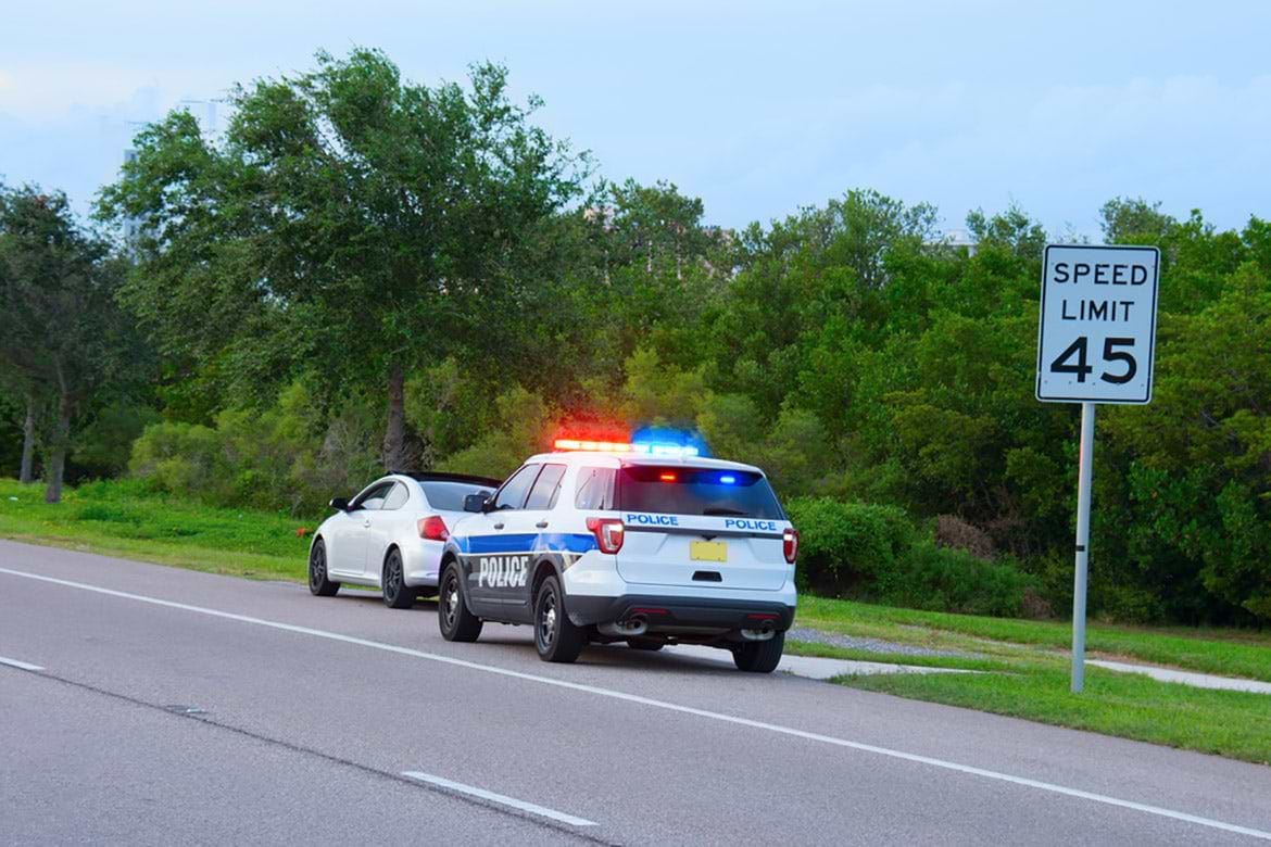 traffic stop police SUV pulling over car on side of road