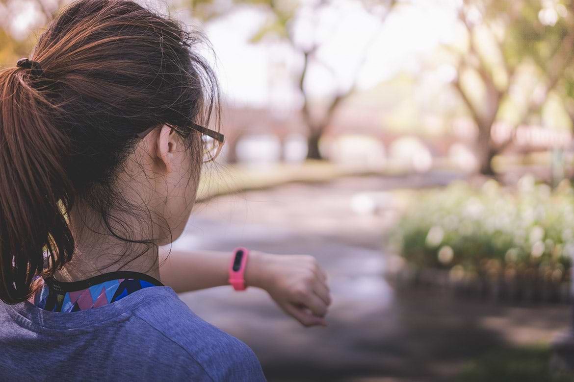 young woman checking her heart rate young woman checking her heart rate