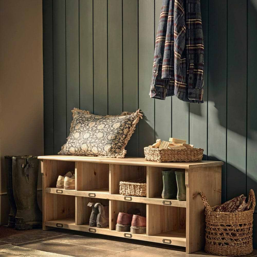A wooden show storage unit in a green hallway.