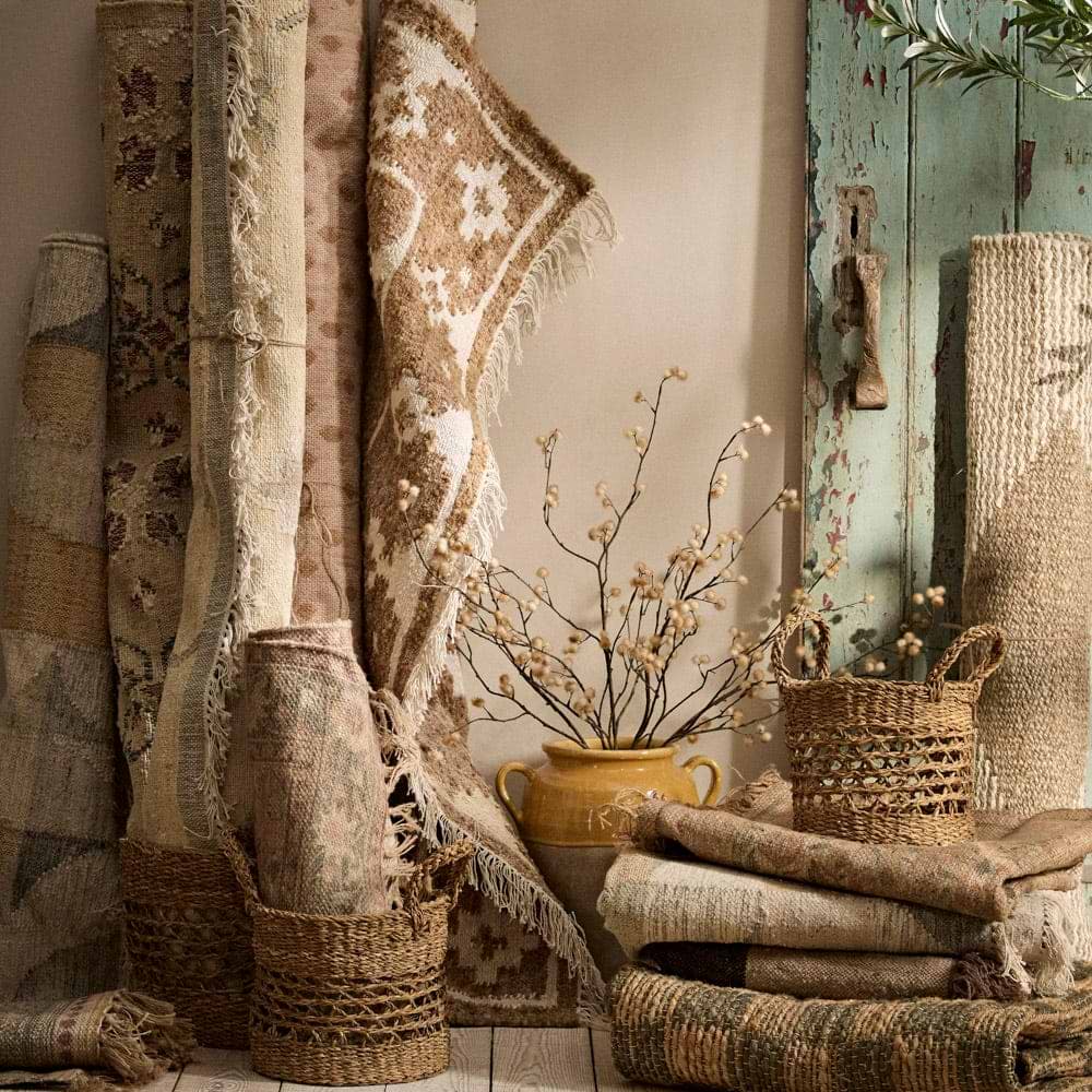Rugs and accessories leaning against a wall